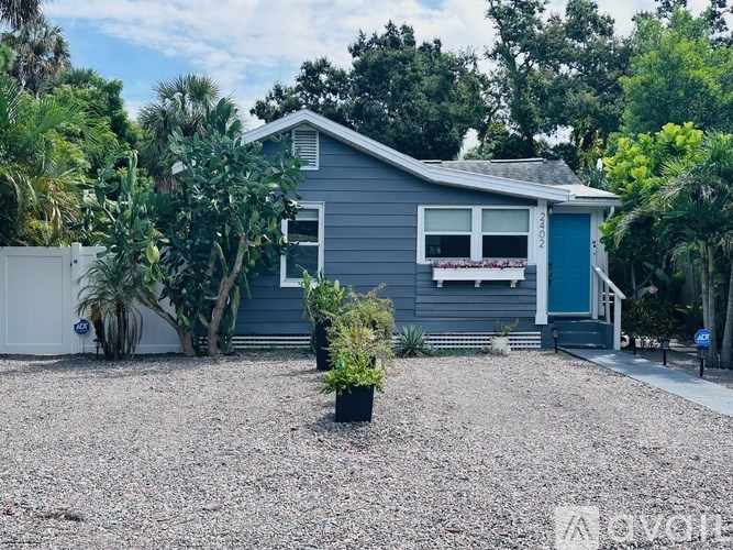 A house with a blue door and a small front yard.