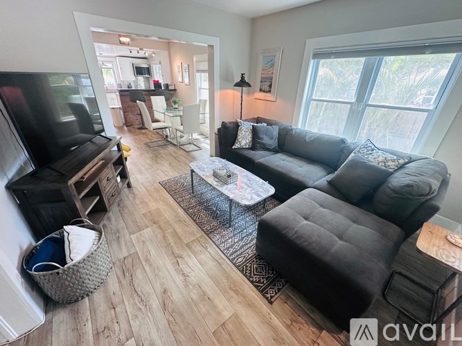 A living room with a grey couch and a coffee table.