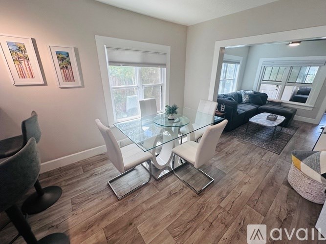 A living room with a glass table and chairs.