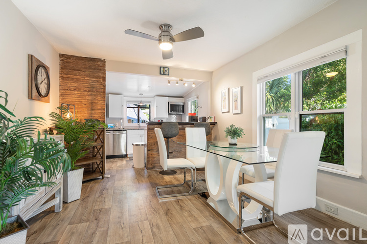 A kitchen with a bar counter and two chairs.