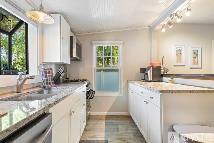 A living room with a couch and a painting on the wall.