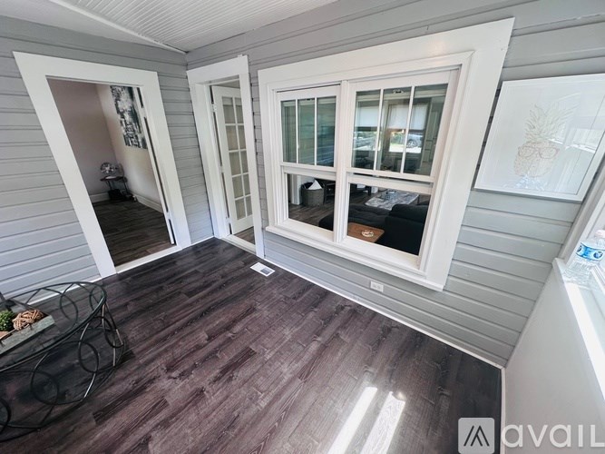 A room with a wooden floor and white walls.