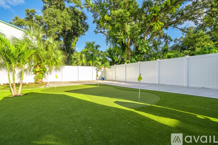 A living room with a grey couch, a coffee table, and a television.
