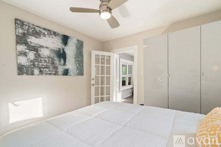 A living room with a grey sofa and a glass coffee table.