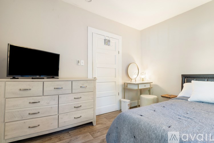 A bedroom with a large bed and a window.