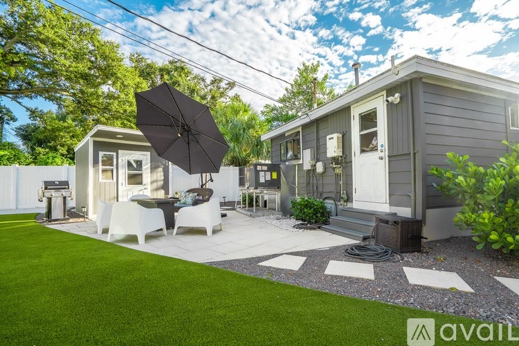 A bedroom with a bed, nightstand, and lamp.