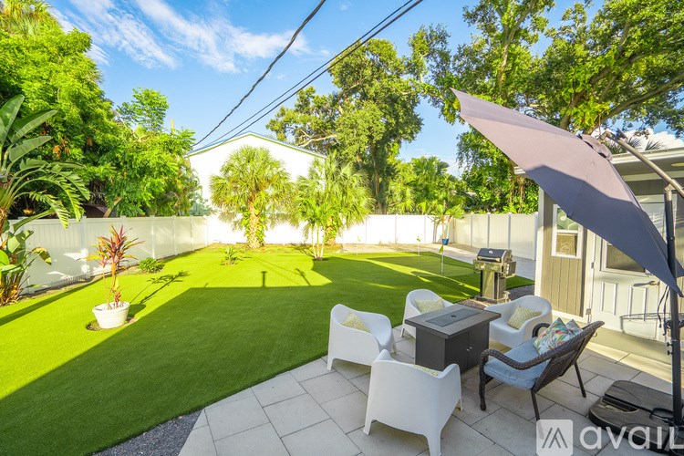 A bedroom with a bed, a dresser, and a TV.