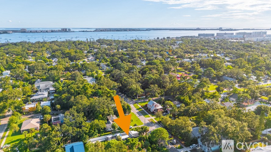 A bathroom with a toilet, sink, and mirror.