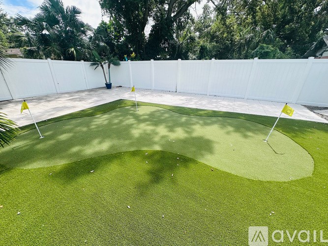 A putting green with two yellow flags on either side.
