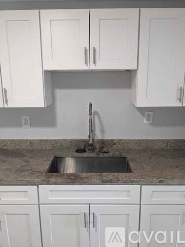 A kitchen with a sink and cabinets.