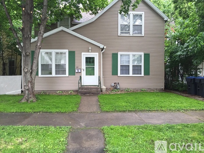 A house with a green door and green shutters.