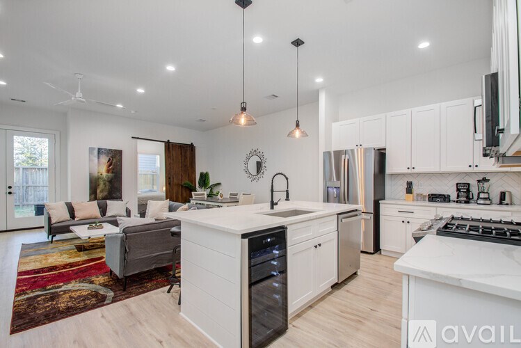 A modern kitchen with white cabinets and a large island.