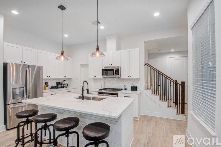 A modern kitchen with white cabinets and a center island.