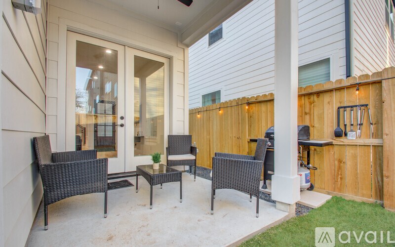 A patio with a table and chairs is available for use.