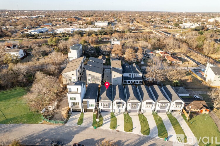 A bird's eye view of a residential area with houses and trees.