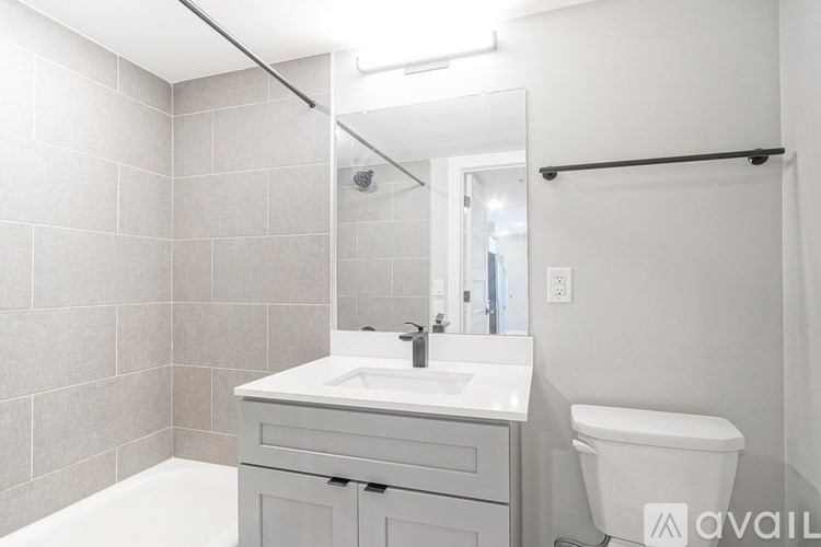 A bathroom with a white sink, toilet, and bathtub.