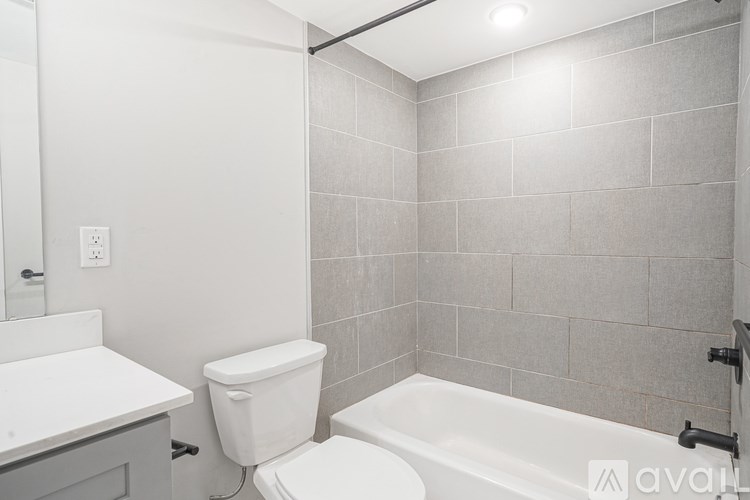 A white toilet sits next to a white sink in a bathroom.