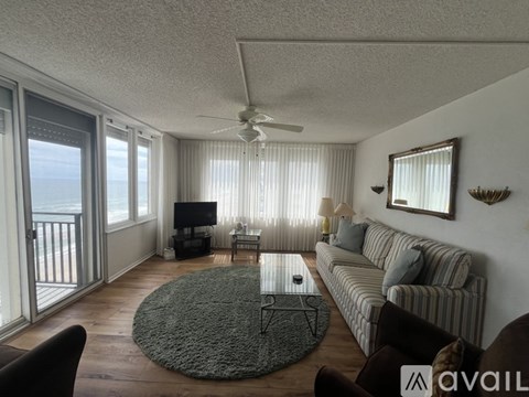 A living room with a striped couch and a television.