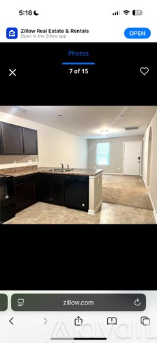 A kitchen with black cabinets and a countertop is shown.