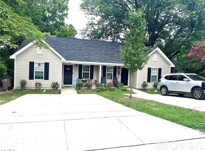A house with a car parked in front.