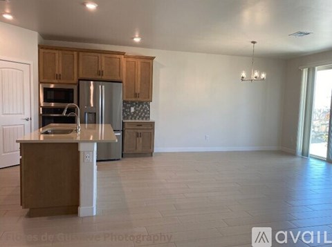 A kitchen with wooden cabinets and a tiled backsplash.