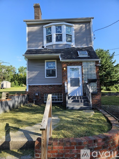 A house with a grey roof and a white door.