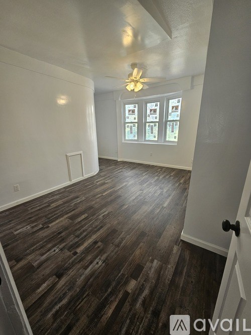 A room with wooden floors and white walls.