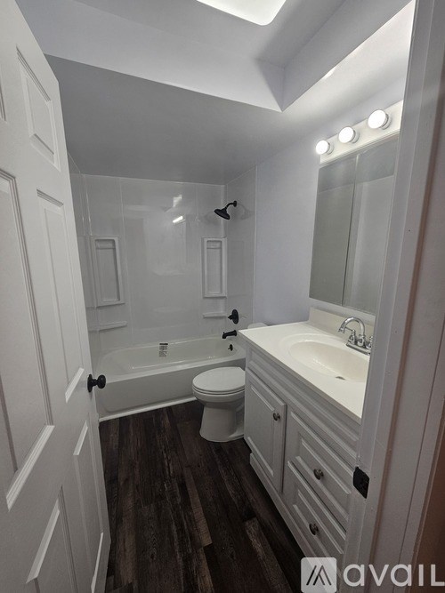 A bathroom with a toilet, sink, and bathtub.