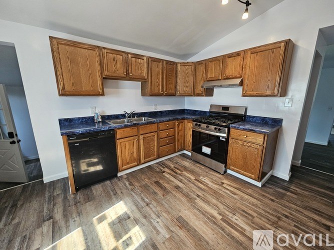 A kitchen with wooden cabinets and a blue countertop.
