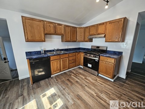 A kitchen with wooden cabinets and a blue countertop.