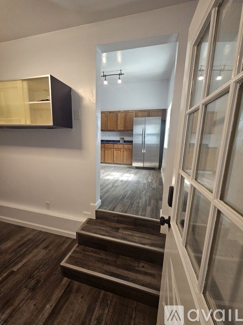 A kitchen with wooden cabinets and a refrigerator.