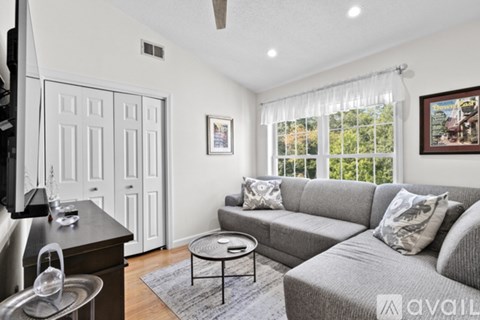 A living room with a grey couch and a coffee table.