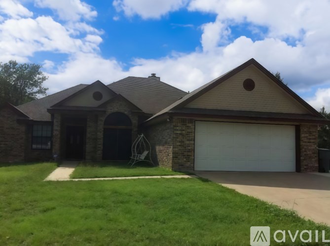 A house with a garage and a driveway in front.