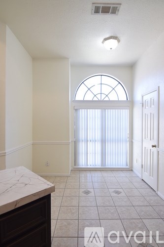 A room with a marble counter top and a large window.