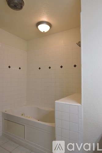 A white bathroom with a tub and a shower.