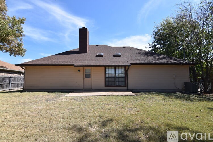 A house with a brown roof and a chimney is available for sale.