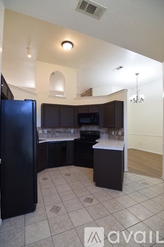 A kitchen with black appliances and a black refrigerator.