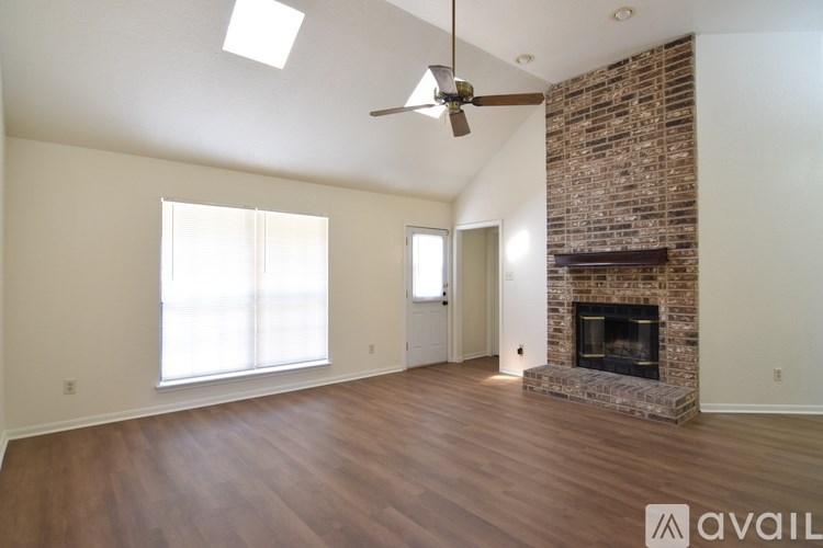 A room with a fireplace and a ceiling fan.