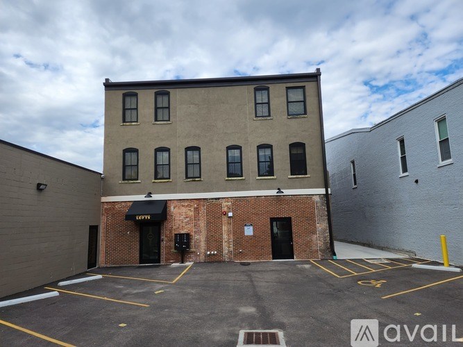 A building with a parking lot in front of it.