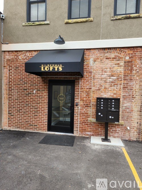 A black awning with the word "Lofts" written in gold on it.