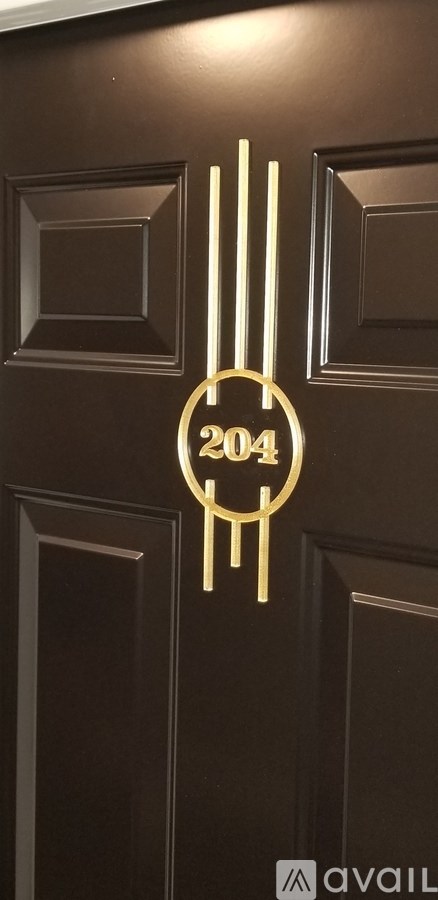 A brown door with a gold number 204 on it.