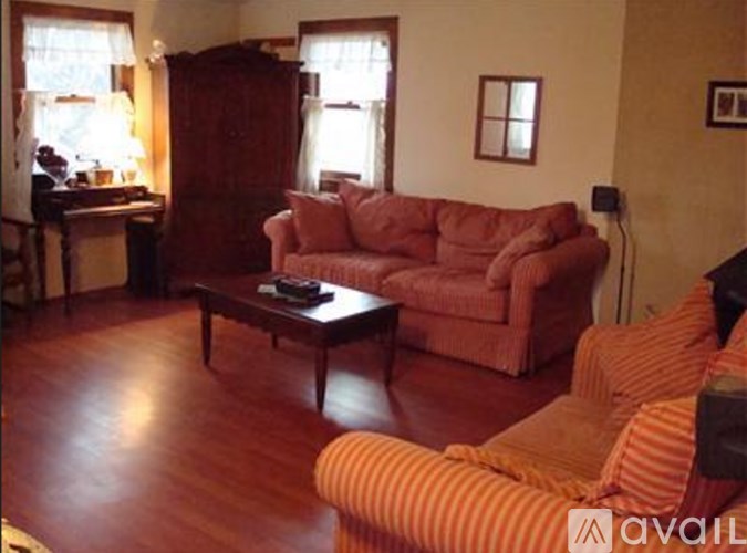 A living room with a red couch and a coffee table.