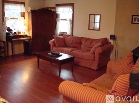 A living room with a red couch and a coffee table.