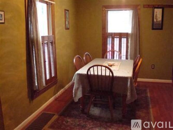 A dining room with a table set for four.