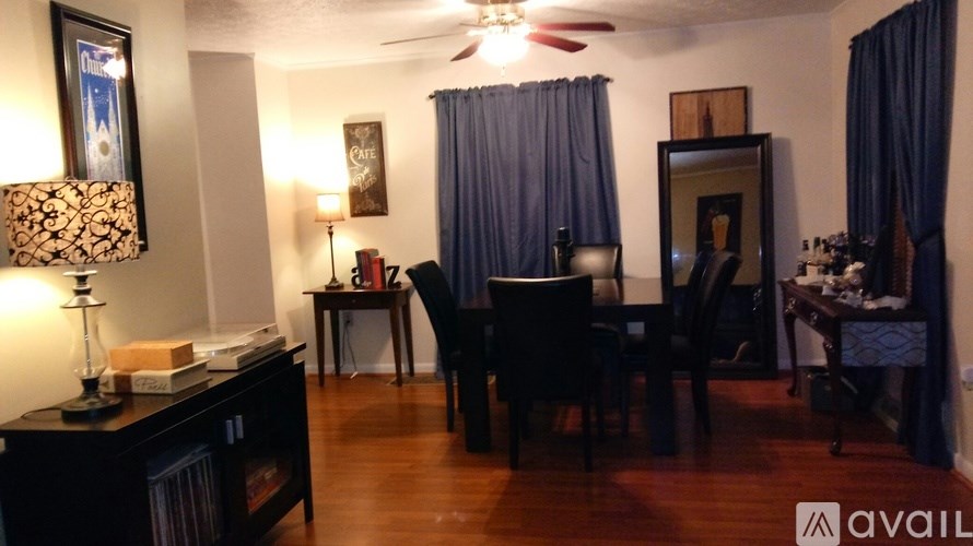 A living room with a dark wood floor and furniture.