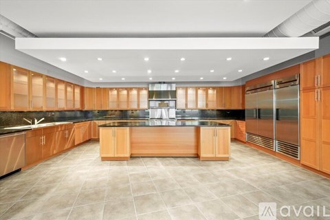 A kitchen with wooden cabinets and a central island.