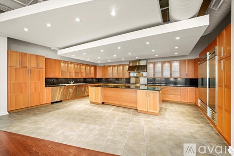 A spacious kitchen with wooden cabinets and a central island.