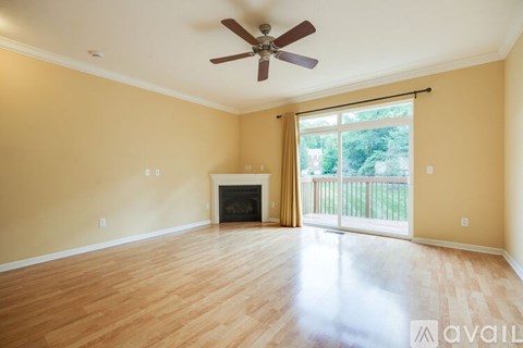 A spacious room with a fireplace and sliding glass doors.