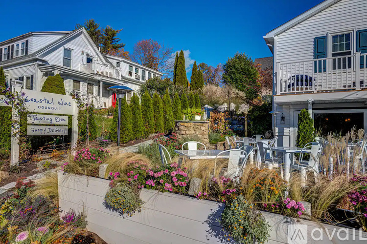 A sign that says "Coastal Wine Dining Room" is in front of a house.