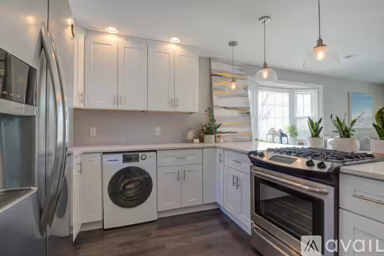 A kitchen with white cabinets and stainless steel appliances.